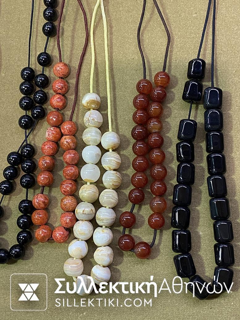 A collection of 15 rosaries made of various artificial and natural materials