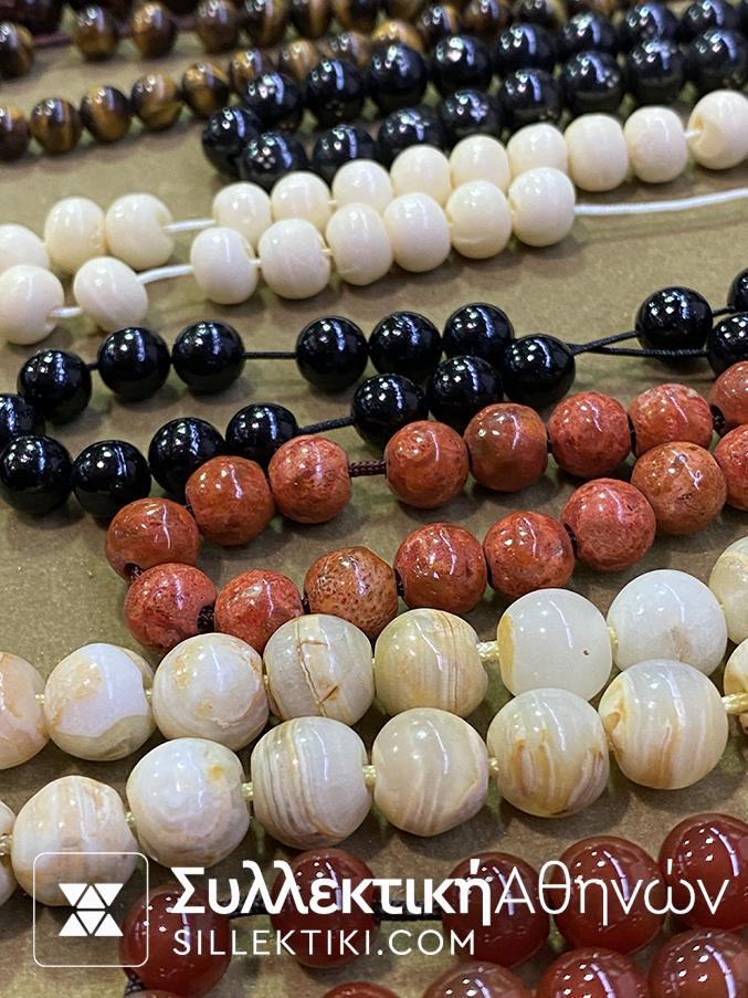 A collection of 15 rosaries made of various artificial and natural materials